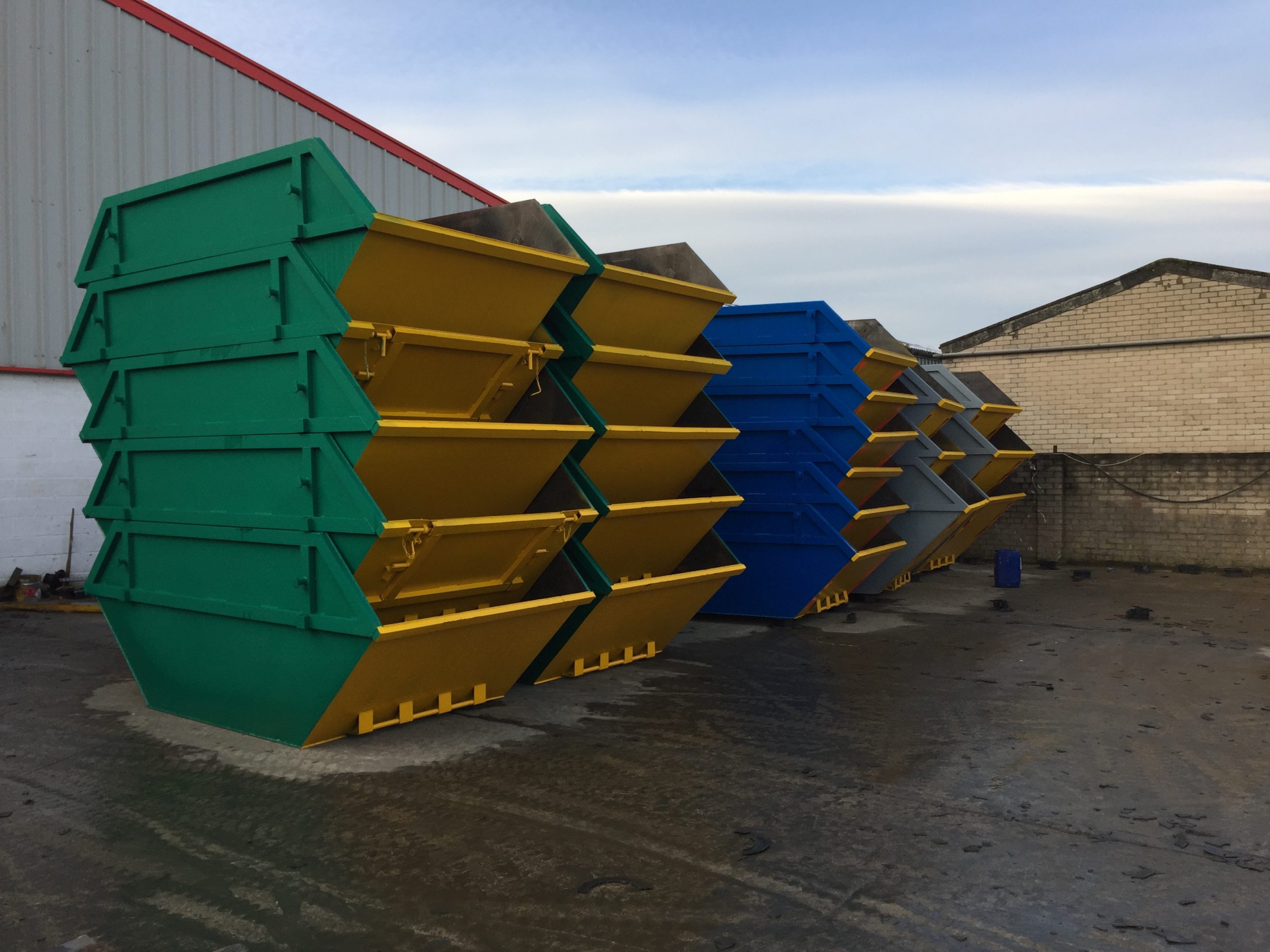 Stack of skips in different colours